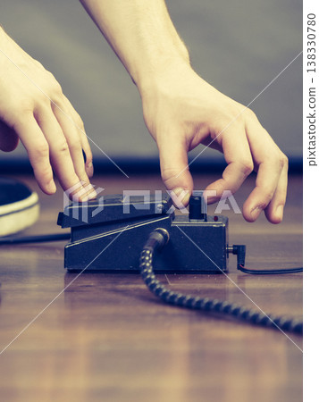 Man adjusting guitar effects pedal Man adjusting guitar effects pedal 138330780