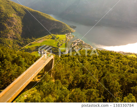 Tourist enjoying fjord view on Stegastein viewpoint Norway Tourist enjoying fjord view on Stegastein viewpoint Norway 138330784