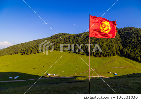 Majestic landscape with national flag, yurts, and hills in Kyrgyzstan Majestic landscape with national flag, yurts, and hills in Kyrgyzstan 138331036