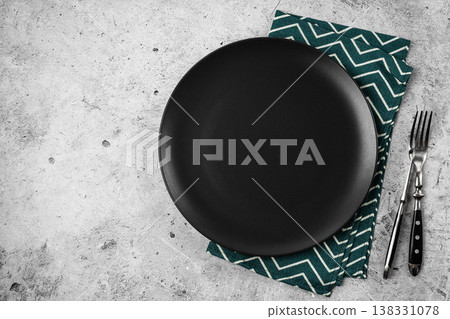 Black Matte Plate with Cutlery on Concrete Background 138331078