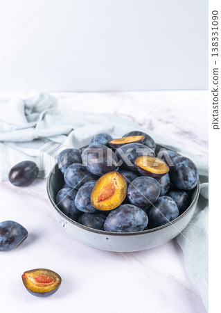 Fresh plums in a clay bowl. 138331090