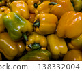 Top view of colorful mix of fresh organic yellow, orange and green bell peppers background pattern at farmers market 138332004