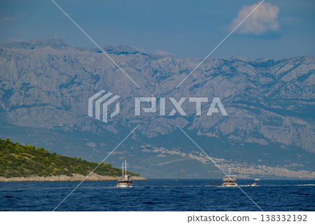Tourist boats on Adriatic Sea with Biokovo Mountain Range Backdrop in Makarska riviera, Croatia 138332192