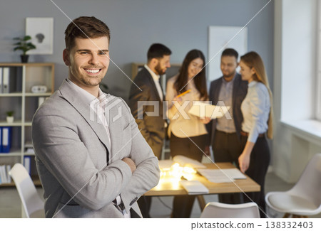 Portrait of skilled businessman office worker dressed in formal suit, standing in office 138332403