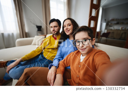 Family enjoying togetherness at home on a cozy afternoon Family enjoying togetherness at home on a cozy afternoon 138332734