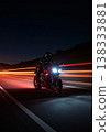 Red Sport Motorcycle Riding Fast on Highway at Night with Motion Blur 138333881