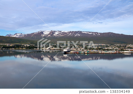 Akureyri, a city in northern Iceland, a Nordic island nation, with the fjord town of Eyjafjörður and snow-capped mountains in the background. 138334149