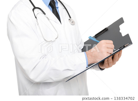 Midsection of a professional doctor in a white coat with a stethoscope writing medical notes on a clipboard, isolated on a white background. Midsection of a professional doctor in a white coat with a stethoscope writing medical notes on a clipboard, isolated on a white background. 138334702