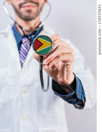 Guyana health and medical insurance concept. Guyana healthcare system, doctor holding stethoscope Guyana health and medical insurance concept. Guyana healthcare system, doctor holding stethoscope 138335641