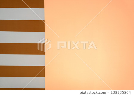 Abstract architectural Minimalist abstract background with a vertical split between orange and white horizontal stripes and a solid peach colored surface. Clean modern graphic design with copy space 138335864