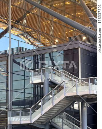 Modern architectural staircase with glass facade and wooden ceiling details 138337201