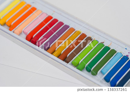 Set of oil pastels in box with white paper. Crayons Set of oil pastels in box with white paper. Crayons 138337261
