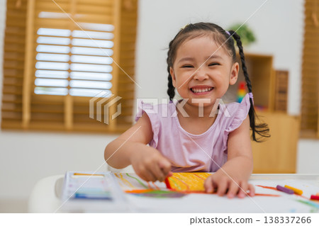 happy preschool child girl drawing and painting with colorful oil pastels on paper happy preschool child girl drawing and painting with colorful oil pastels on paper 138337266