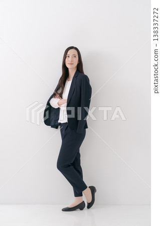 A woman with long hair wearing a jacket A woman with long hair wearing a jacket 138337272