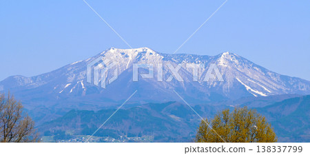 Mount Iizuna, still covered in snow, as seen from Nagano City. Mount Iizuna, still covered in snow, as seen from Nagano City. 138337799