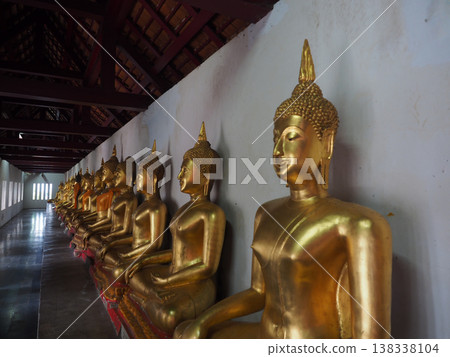Buddha statue gold religion temple corridor peaceful meditation row Buddha statue gold religion temple corridor peaceful meditation row 138338104