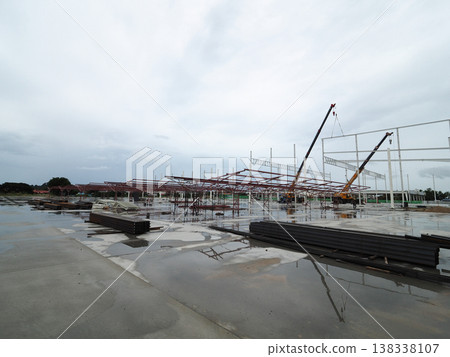 Construction site steel structure building frame crane wet concrete overcast sky captures Construction site steel structure building frame crane wet concrete overcast sky captures 138338107