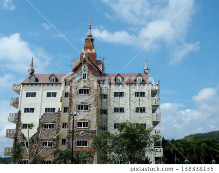 Ornate building renovation scaffolding tower architecture construction facade temple sky cloud 138338135