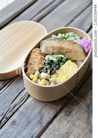 Japanese bento box with teriyaki yellowtail and edamame and salted kelp rice. 138338444