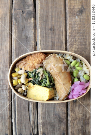 Japanese bento box with teriyaki yellowtail and edamame and salted kelp rice. Japanese bento box with teriyaki yellowtail and edamame and salted kelp rice. 138338446