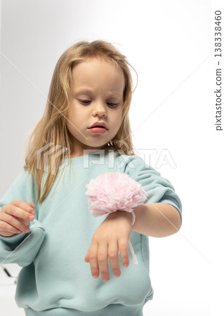 Portrait of beautiful cute little toddler girl. Child with funny face in mint sweatshirt. Pretty smile kid in studio on white background. High quality photo 138338460