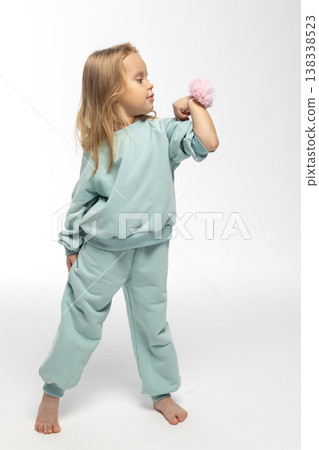 Portrait of beautiful cute little toddler girl. Child with funny face in mint sweatshirt. Pretty smile kid in studio on white background. High quality photo Portrait of beautiful cute little toddler girl. Child with funny face in mint sweatshirt. Pretty smile kid in studio on white background. High quality photo 138338523