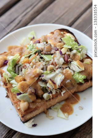 Toast topped with chopped salad served with miso dressing Toast topped with chopped salad served with miso dressing 138338554