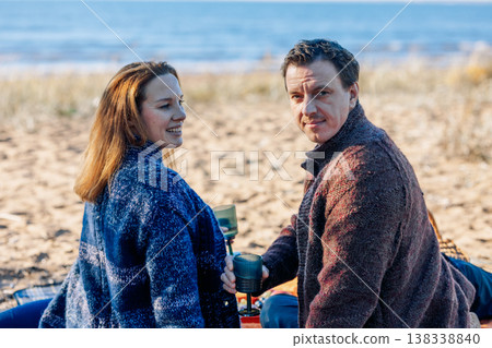 Portrait happy beautiful couple in love enjoying autumn picnic in autumn park. Back view. High quality photo 138338840