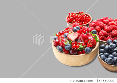 Different berries sit in wooden bowls ready to be enjoyed Different berries sit in wooden bowls ready to be enjoyed 138339000