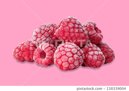 Raspberries are piled together on a bright pink surface 138339004