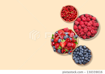 Berries displayed in bowls with red and blue colors Berries displayed in bowls with red and blue colors 138339016