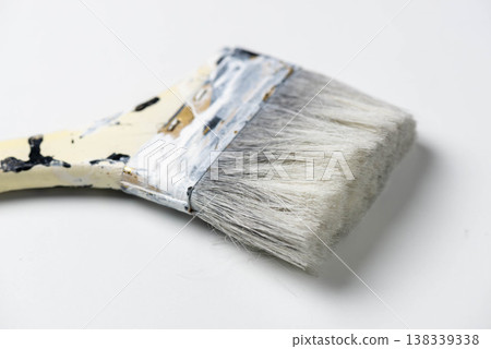 Old paintbrush with paint on it 138339338