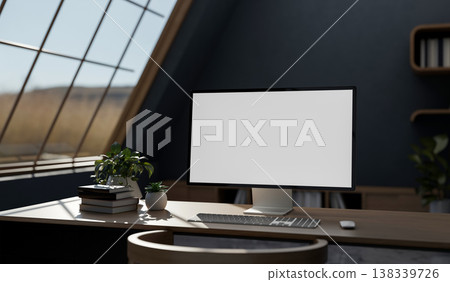 White screen computer with books and pot plant on wooden table aside roof window in blue attic room. White screen computer with books and pot plant on wooden table aside roof window in blue attic room. 138339726