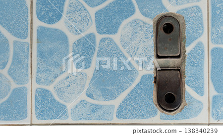 Above view of foldable steel frame for securing sliding steel doors. It was securely fastened to the floor which was covered with light blue patterned tiles. Above view of foldable steel frame for securing sliding steel doors. It was securely fastened to the floor which was covered with light blue patterned tiles. 138340239
