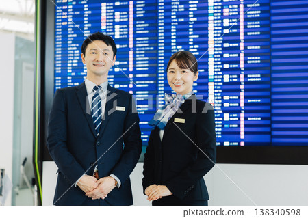 Airport ground staff (male and female) providing guidance. "Filming cooperation: Kansai International Airport (KIX)" 138340598