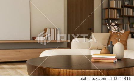 Books and flower vase on round wooden table and sofa across the door and bookshelf in a modern room. Books and flower vase on round wooden table and sofa across the door and bookshelf in a modern room. 138341416