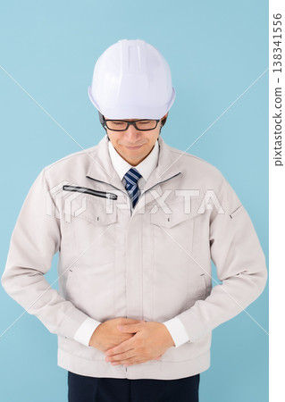 Man in work clothes bowing Man in work clothes bowing 138341556
