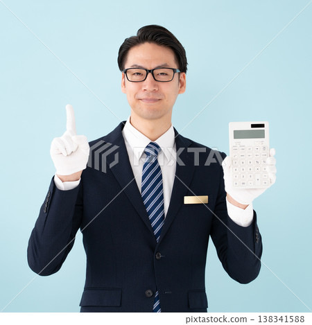 Man wearing white gloves holding a calculator Man wearing white gloves holding a calculator 138341588