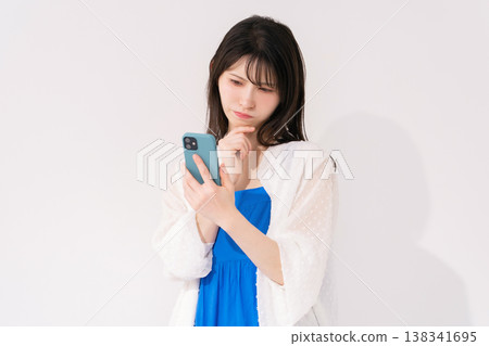 A woman with a smart phone suffers 138341695