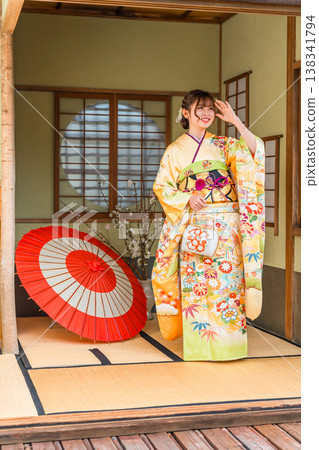 A young Japanese woman wearing a furisode kimono in a Japanese-style room (coming-of-age ceremony, 20th birthday celebration) A young Japanese woman wearing a furisode kimono in a Japanese-style room (coming-of-age ceremony, 20th birthday celebration) 138341794