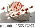 Pink strawberry margarita cocktail with sugar rim on marble tray. Fresh halved berries floating in sparkling rose drink with ice and sunlight shadows for summer party lifestyle. 138343293