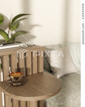 Latte art coffee in cup with book and eyeglasses on layered wooden shelf aside a sofa and white wall 138343456