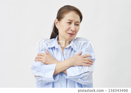 Senior women huddle together in the cold. 138343498