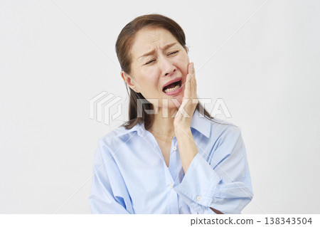 Woman suffering from toothache on white background Woman suffering from toothache on white background 138343504