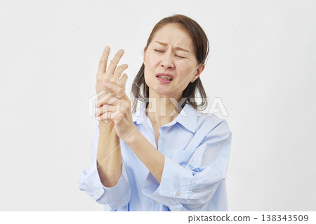 Woman suffering from hand pain on white background Woman suffering from hand pain on white background 138343509