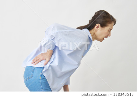 Woman suffering from back pain on white background Woman suffering from back pain on white background 138343513