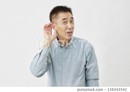 Man listening intently on white background Man listening intently on white background 138343542