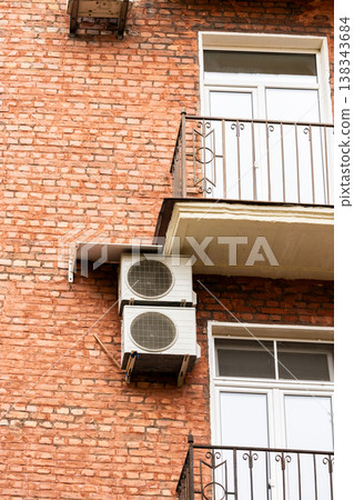 air conditioning on facade of building, air cooling in hot weather. air conditioning on facade of building, air cooling in hot weather. 138343684