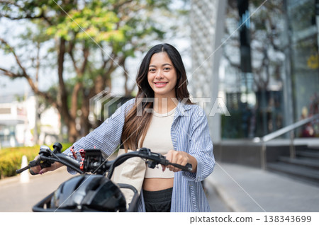 Pretty asian woman walking with bicycle on pavement or sidewalk in city park or shopping mall plaza. Pretty asian woman walking with bicycle on pavement or sidewalk in city park or shopping mall plaza. 138343699
