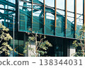 A railway bridge and train reflected in the city's buildings. 138344031